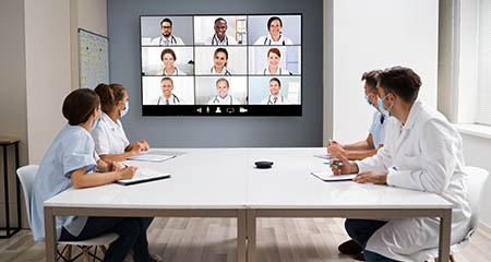 Doctors sharing findings during a virtual meeting.
