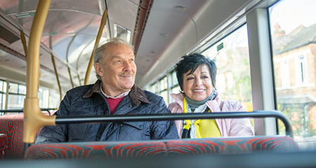 A couple sitting together on the bus.
