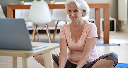 A woman taking an online exercise class.