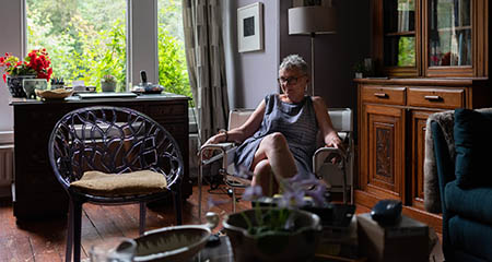 Person relaxing in an armchair at home.