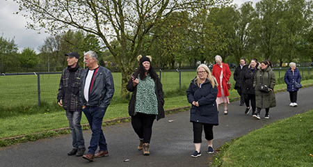 A group of people walking in the park.